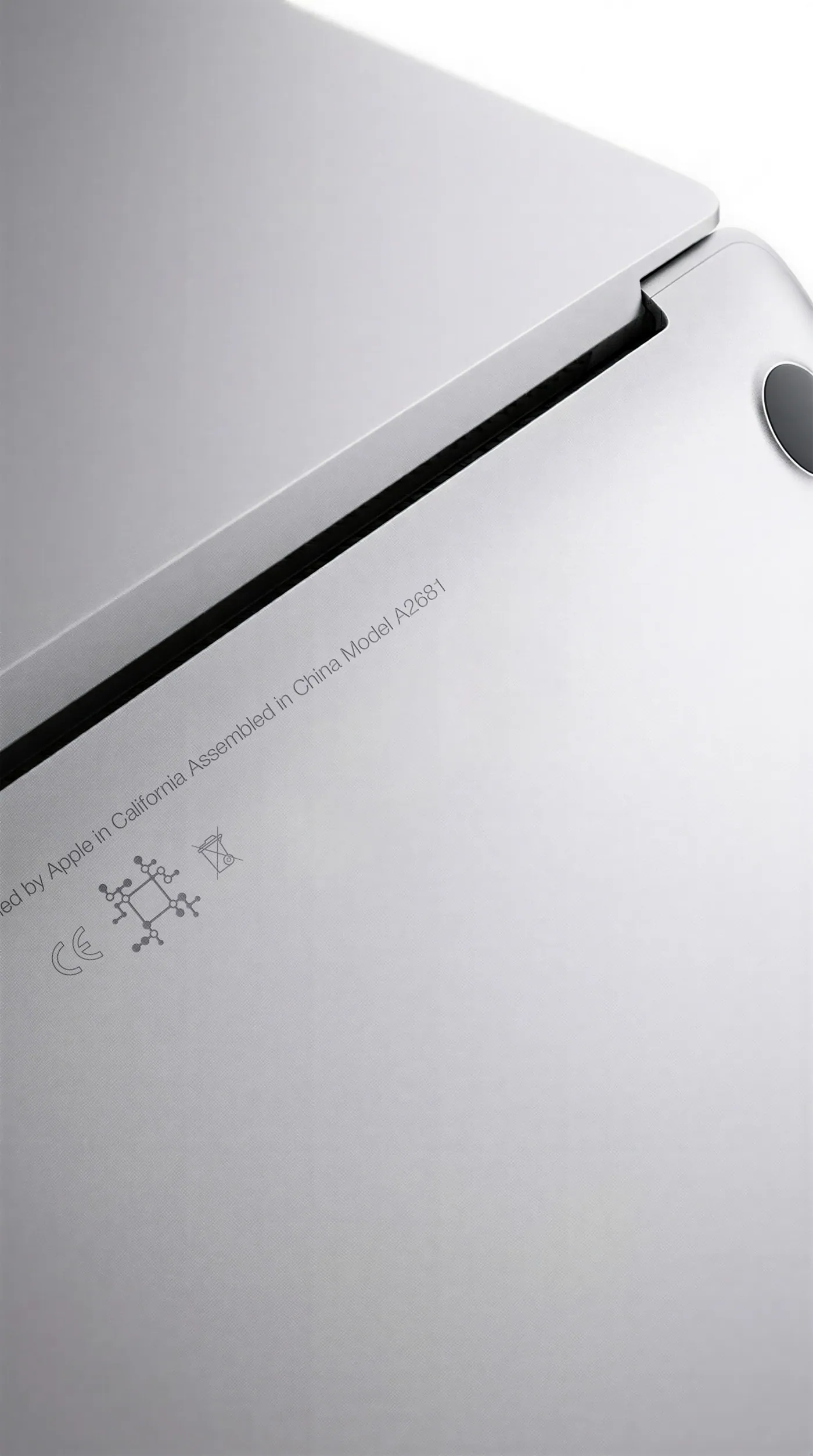 The underside of a silver laptop with a VPI code engraved beside the regulatory marks.