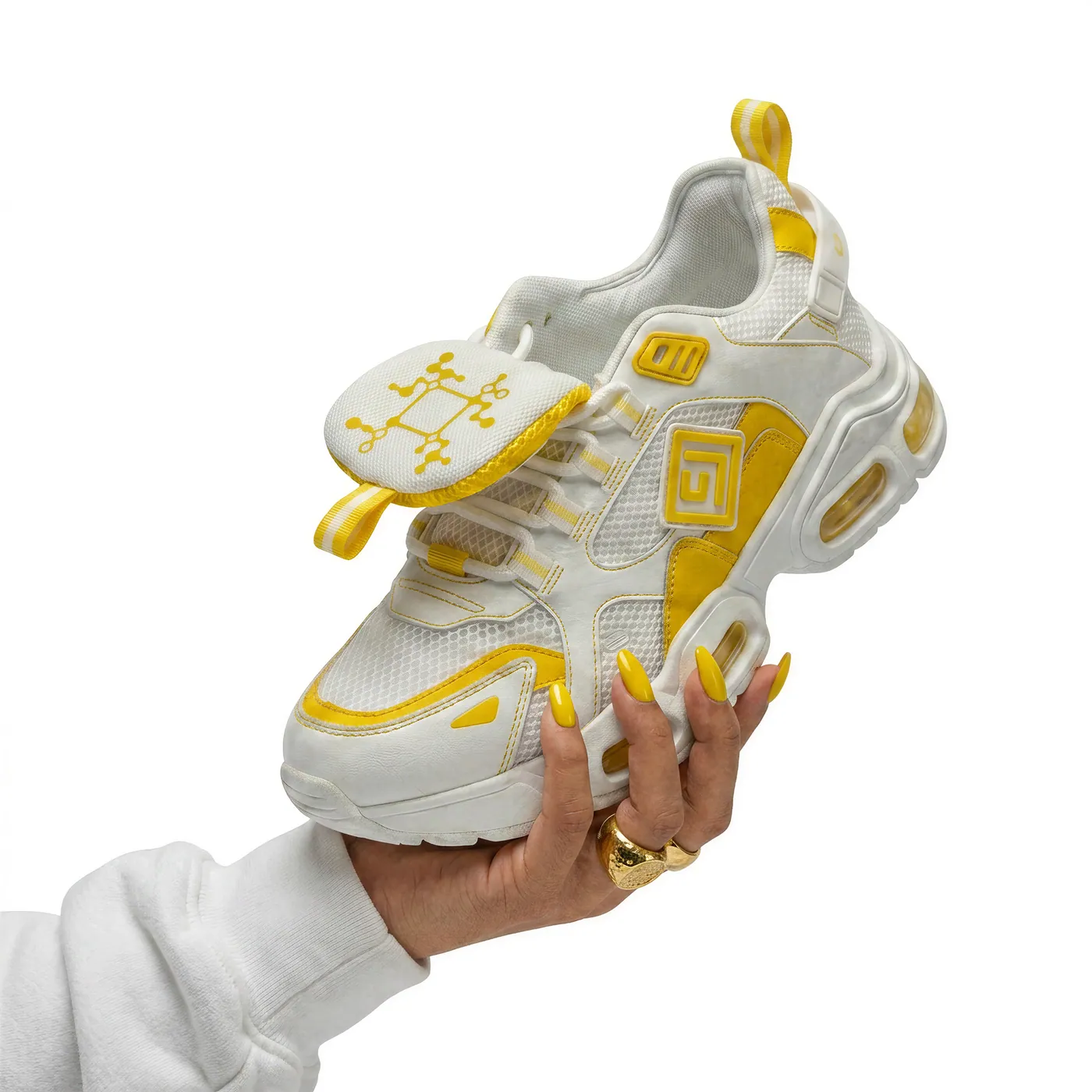 A white and yellow trainer with a VPI code embroidered on the tongue.